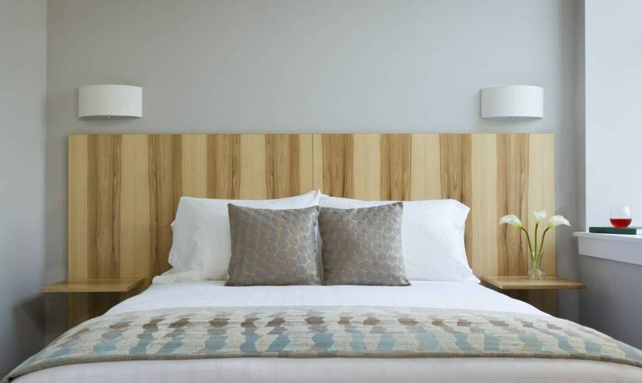 Łóżka drewniane z tapicerowanym zagłówkiem – inspiracje i zalety tego połączenia