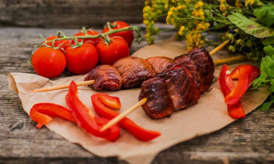 Why do pork cheeks work well in slow-cooked dishes?