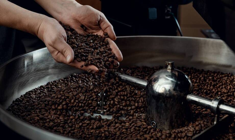How does the choice of roasting machine affect the unique flavor profile of different coffees?