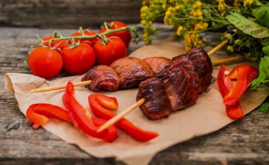 Why do pork cheeks work well in slow-cooked dishes?